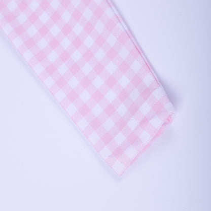 Close up view of the long sleeve cuff on the pink and white gingham fairytale princess girls rash guard swim shirt.