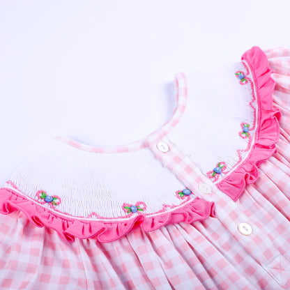 Back collar detail of pink gingham Big Sister smocked dress featuring white buttons and embroidered floral bows.