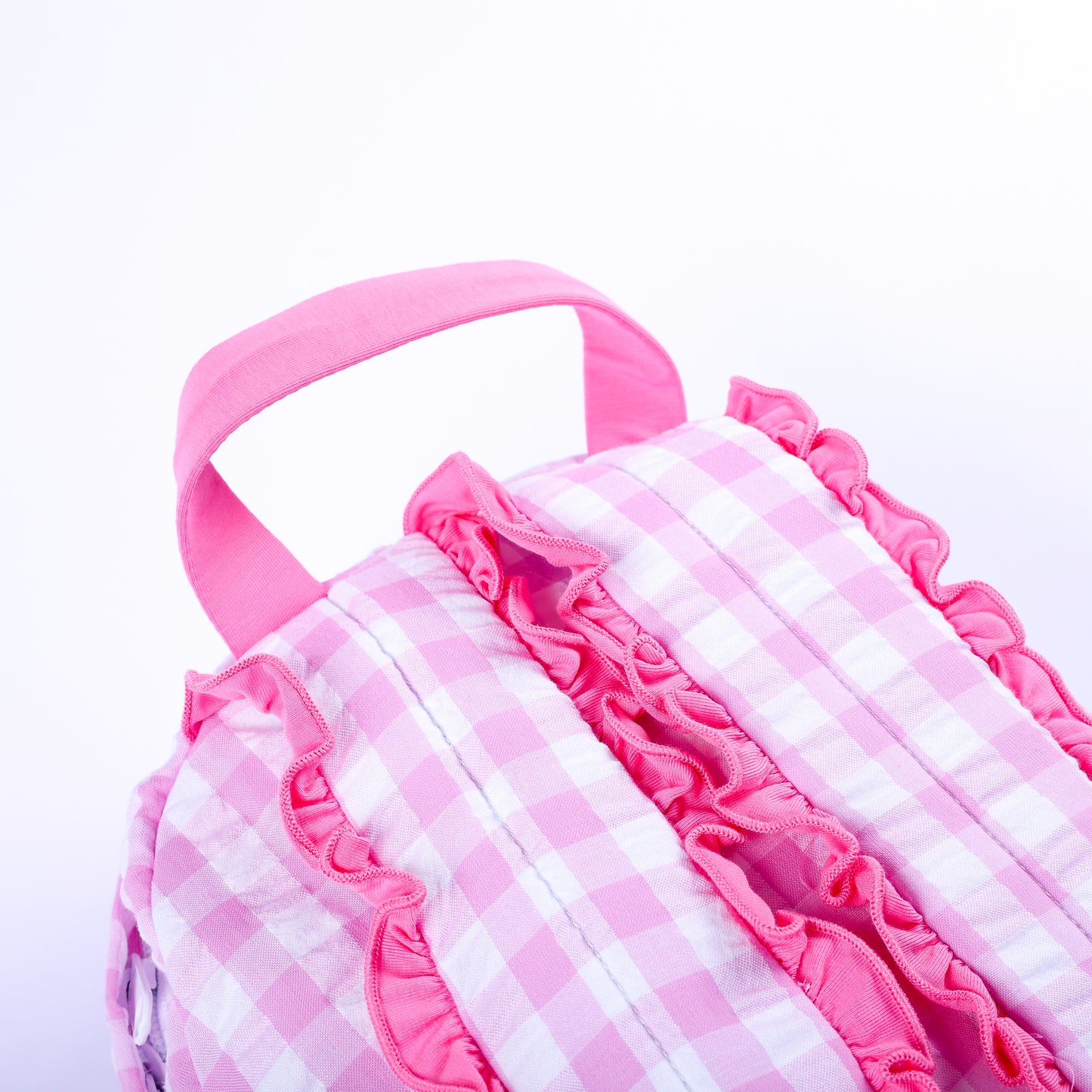 Back view of pink gingham fairytale princess backpack showing top handle and ruffle-trimmed shoulder straps.