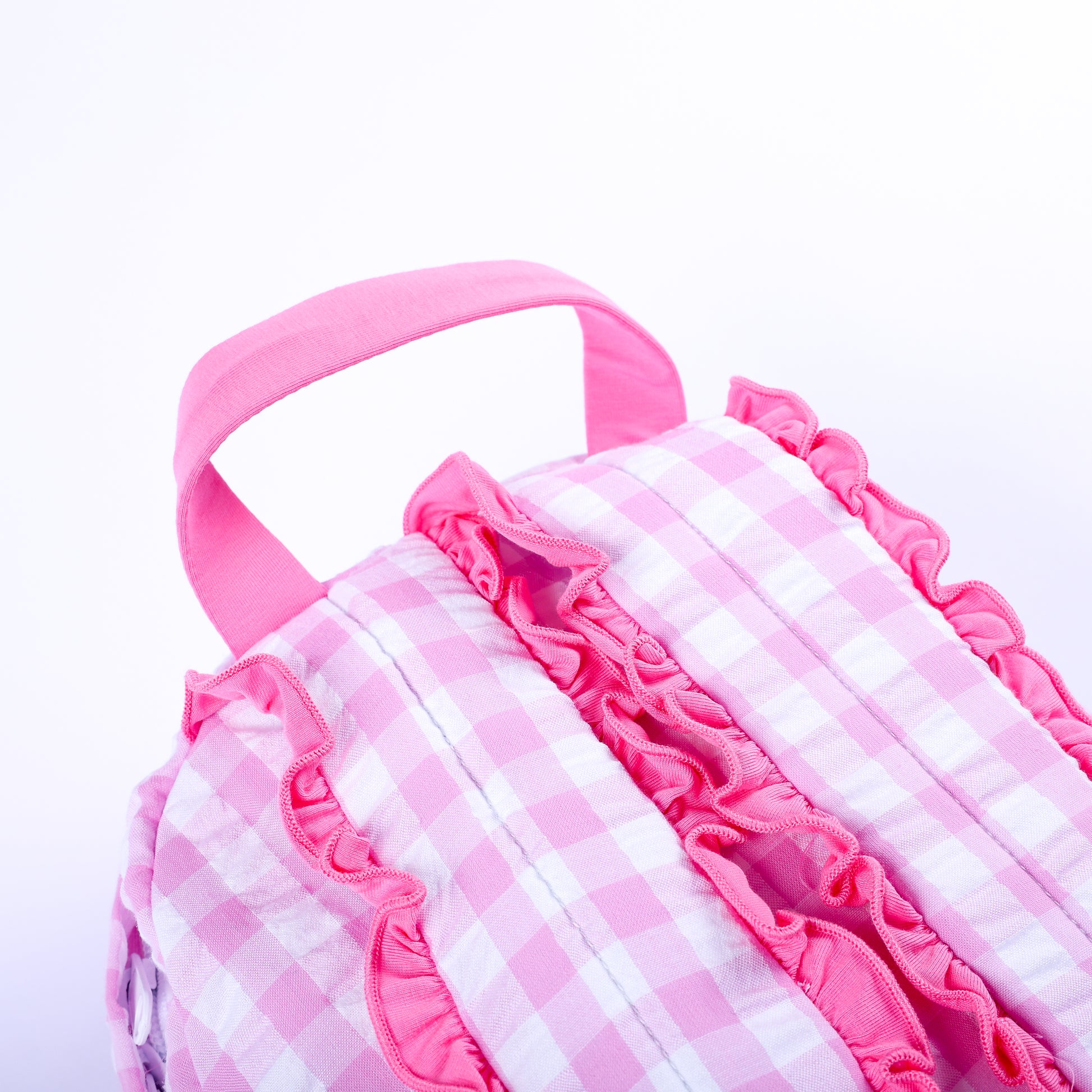 Back view of pink gingham fairytale princess backpack showing top handle and ruffle-trimmed shoulder straps.