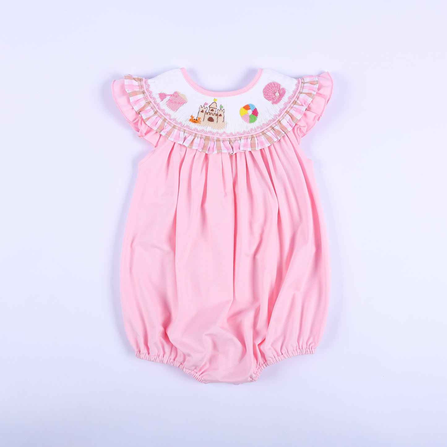 Front view of a pink hand-smocked baby bubble outfit featuring a ruffled beach-themed embroidered collar.