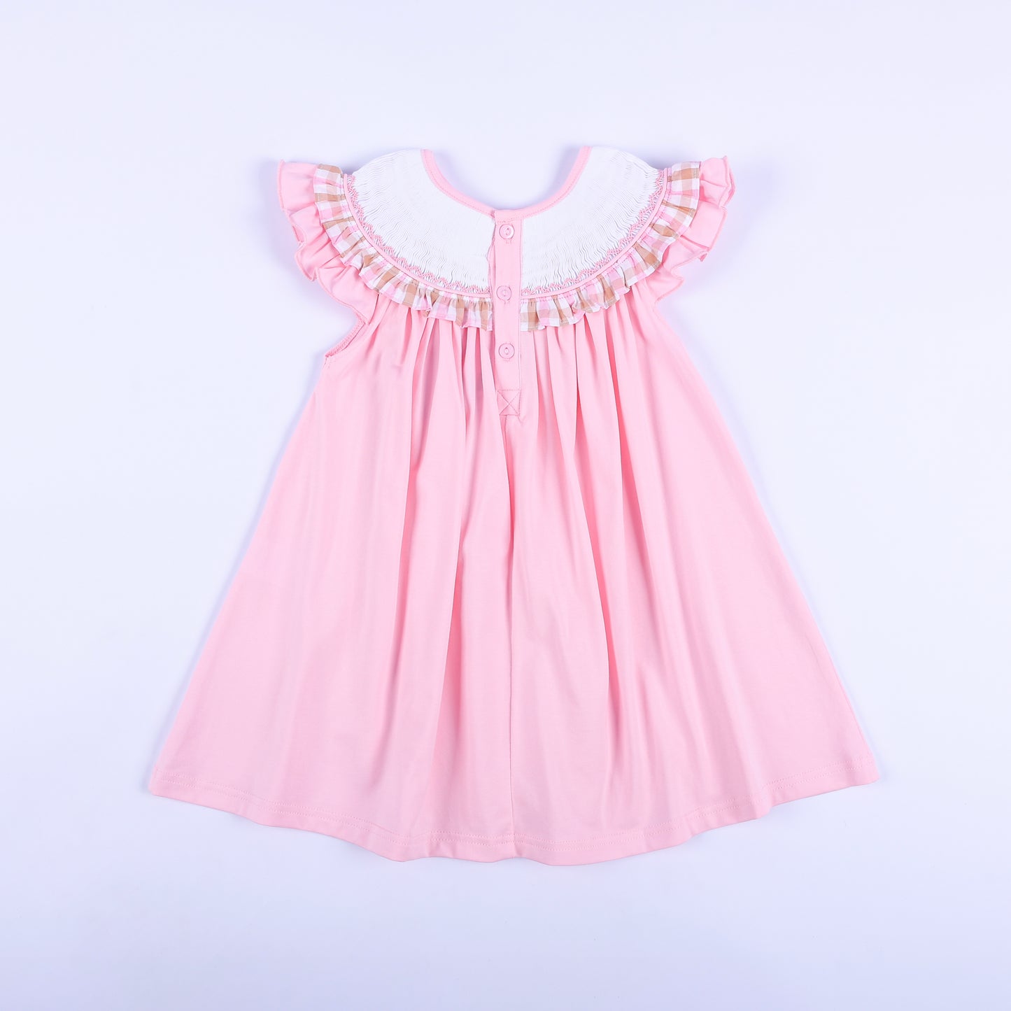 Back view of girls' pink hand smocked beach dress with button closure, ruffle sleeves, and gingham collar trim.