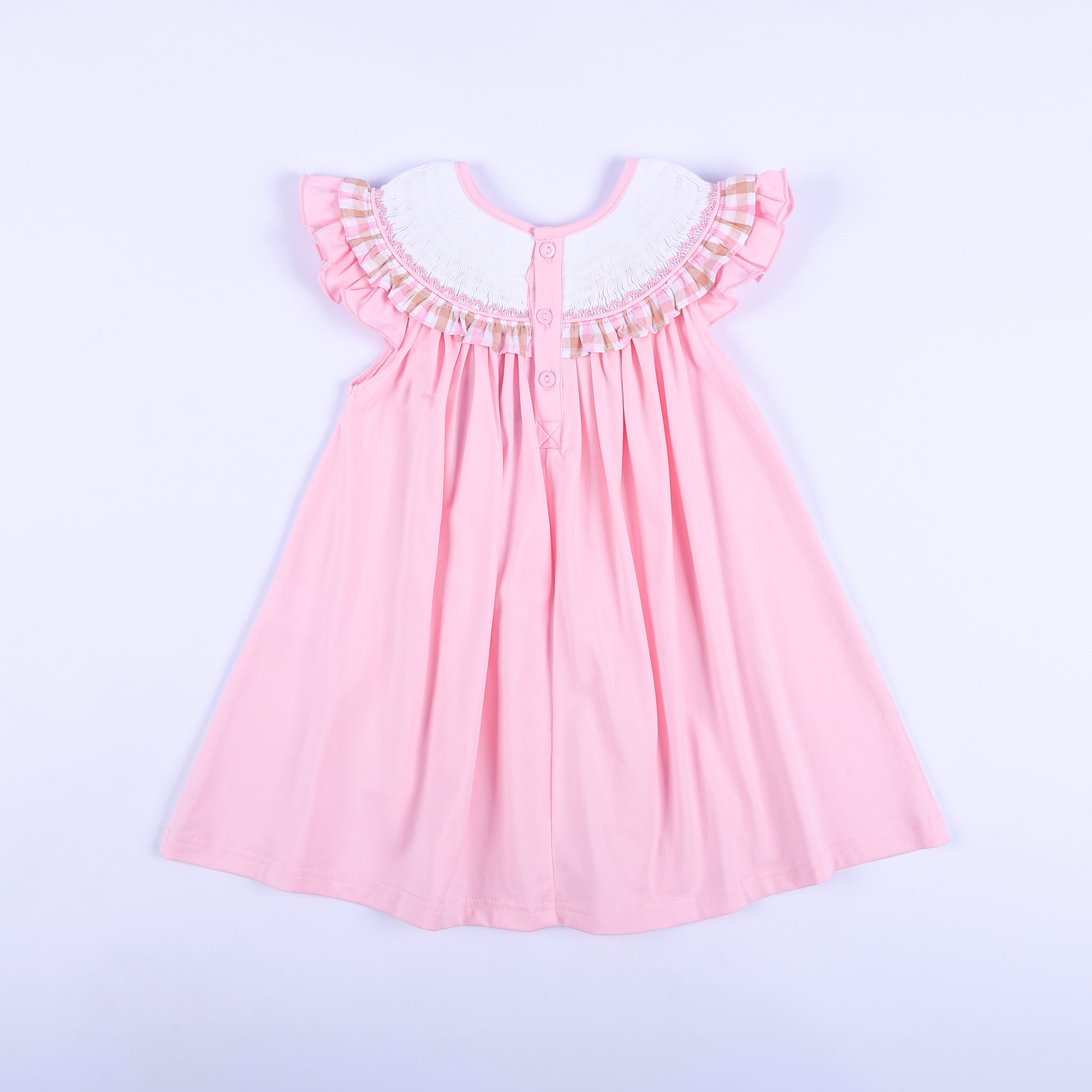 Back view of girls' pink hand smocked beach dress with button closure, ruffle sleeves, and gingham collar trim.