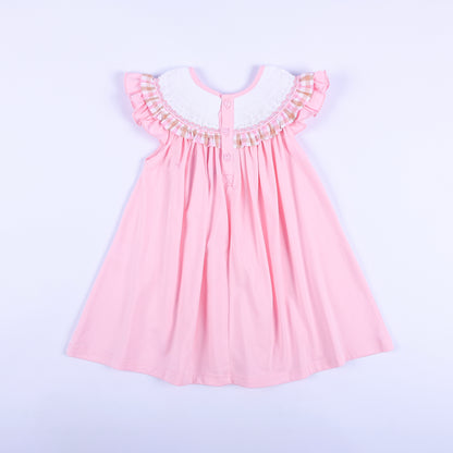 Back view of girls' pink hand smocked beach dress with button closure, ruffle sleeves, and gingham collar trim.
