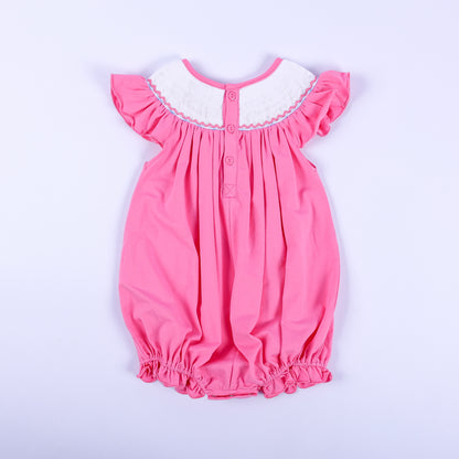 Back view of pink hand-smocked knit bubble romper for baby girls showing classic button placket and flutter sleeves.