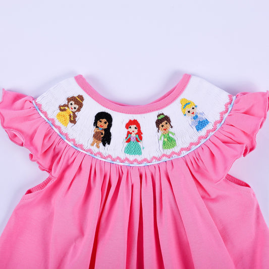 Detailed close-up of hand-smocked princess embroidery on pink knit flutter sleeve baby girl top collar.