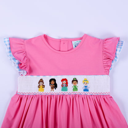 Bodice detail of pink princess knit hand smocked dress with embroidered princesses and blue gingham flutter sleeves.
