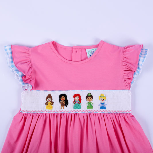 Bodice detail of pink princess knit hand smocked dress with embroidered princesses and blue gingham flutter sleeves.