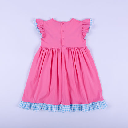 Detailed view of hand smocked plate with colorful hand embroidered princess figures on pink girls knit dress.