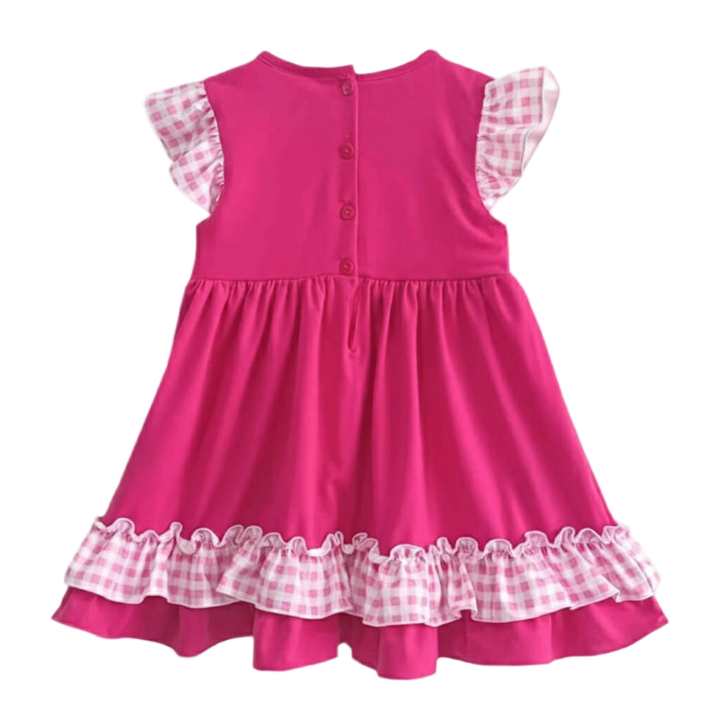 Back view of a hand smocked pink princess dress with buttons and pink gingham ruffles on the sleeves and hem.
