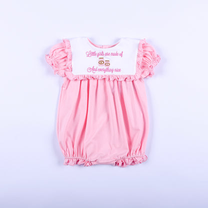Pink embroidered baby girl bubble romper with white ruffled bib collar reading sugar and spice and everything nice.