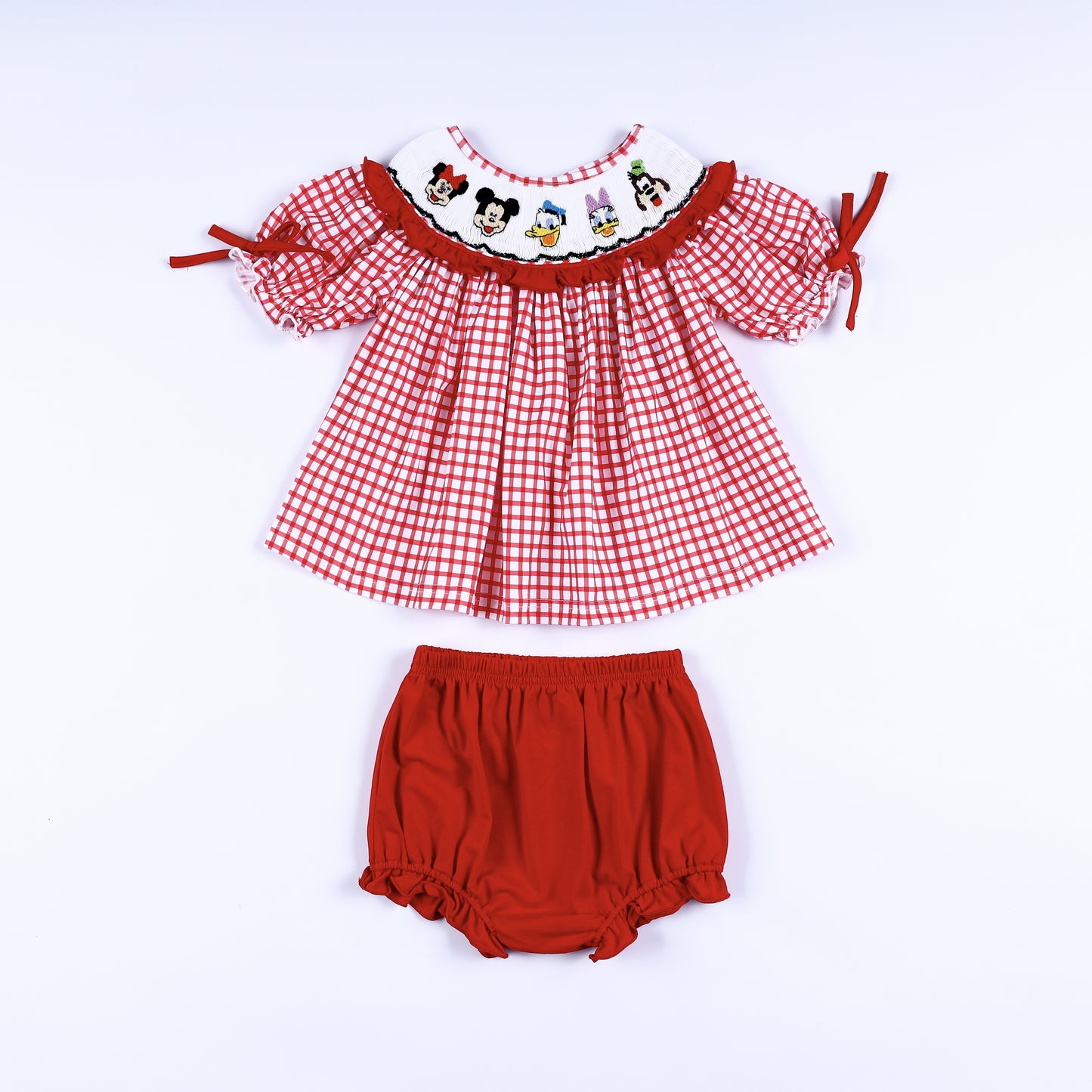 Red gingham hand smocked dress set with embroidered cartoon characters and matching red diaper cover bloomer.
