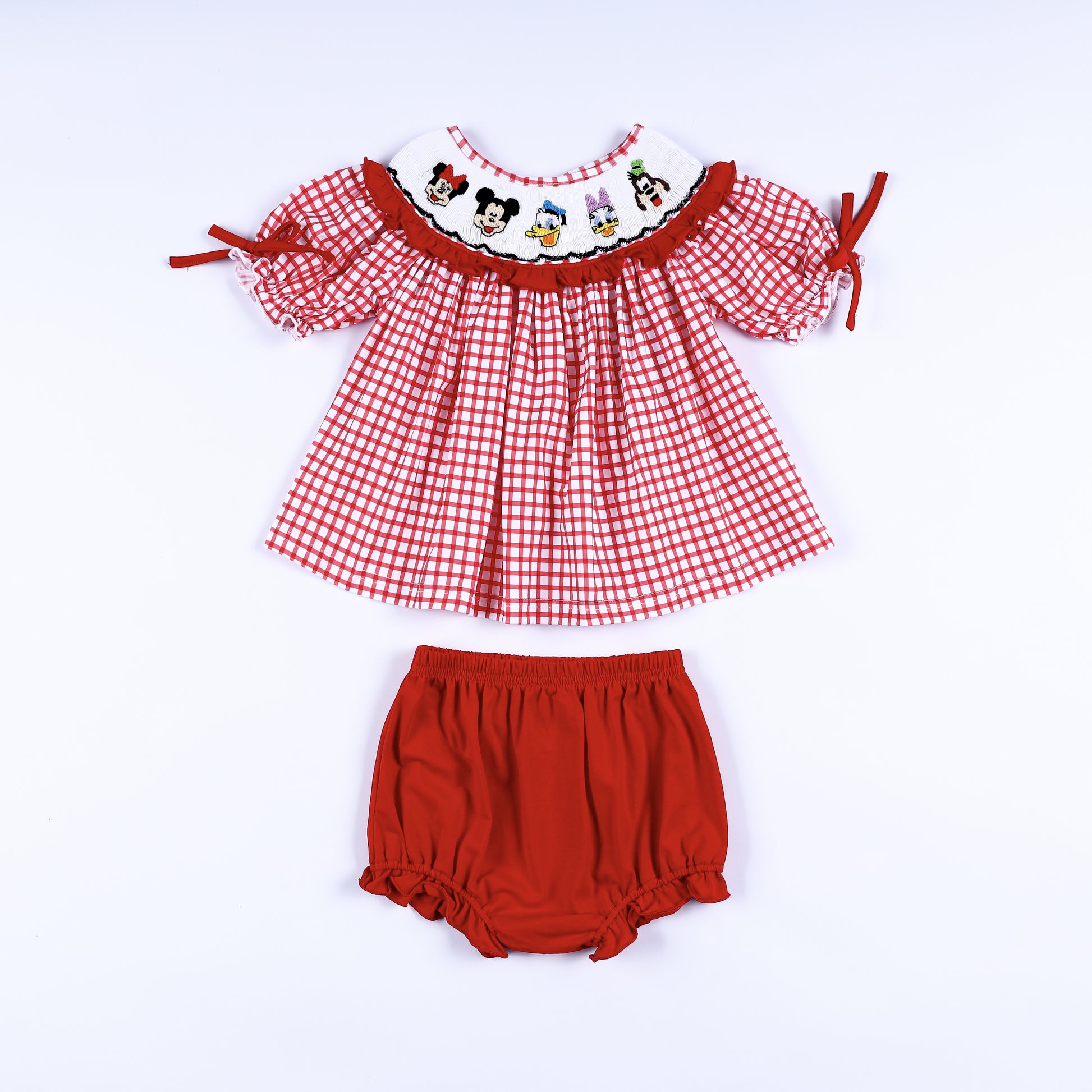 Red gingham hand smocked dress set with embroidered cartoon characters and matching red diaper cover bloomer.