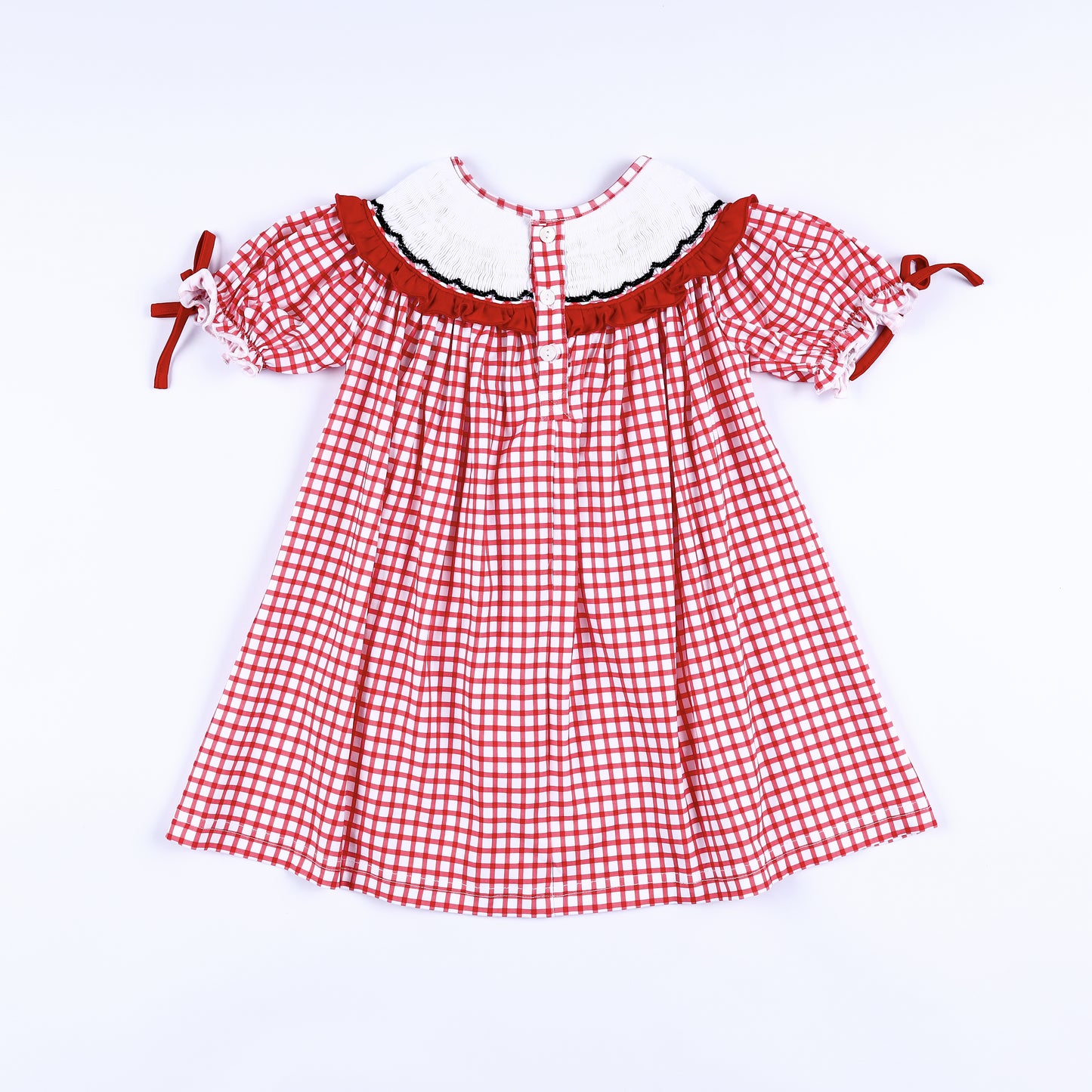 Back view of girls red gingham hand smocked dress showing smocked collar trim and button closure placket.
