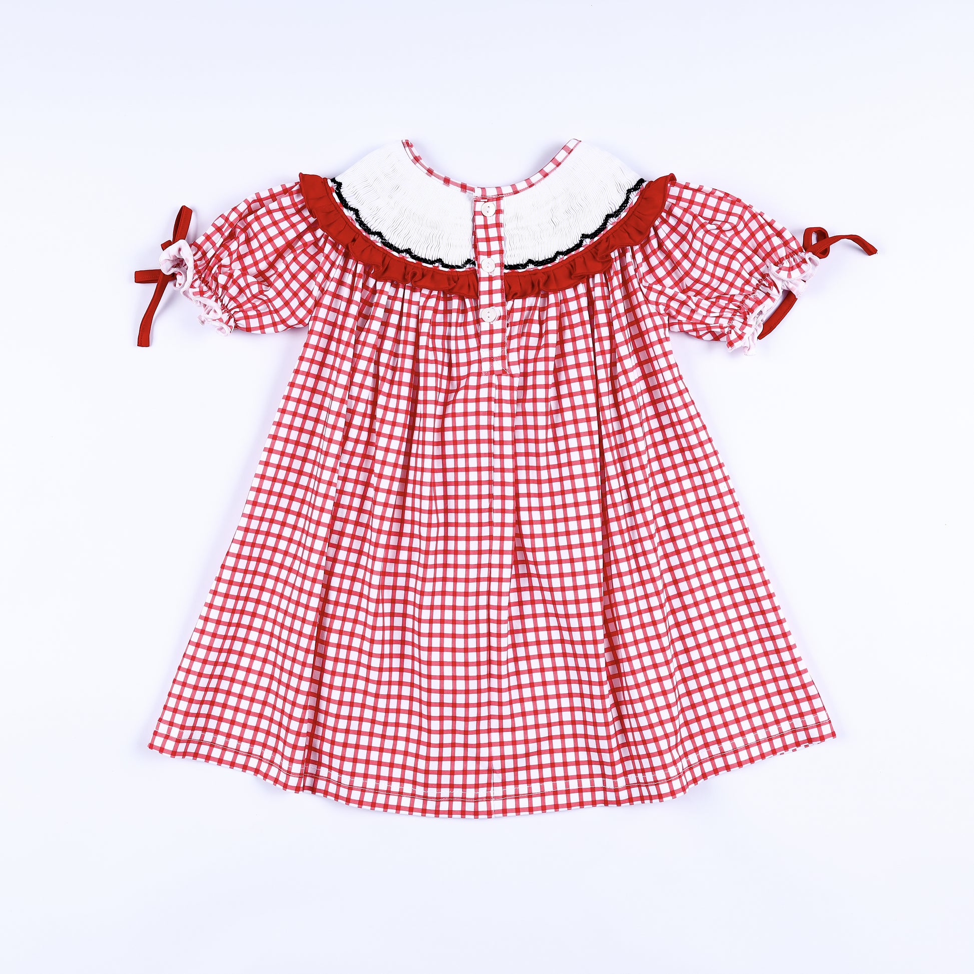 Back view of girls red gingham hand smocked dress showing smocked collar trim and button closure placket.