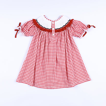 Back view of girls red gingham hand smocked dress showing smocked collar trim and button closure placket.