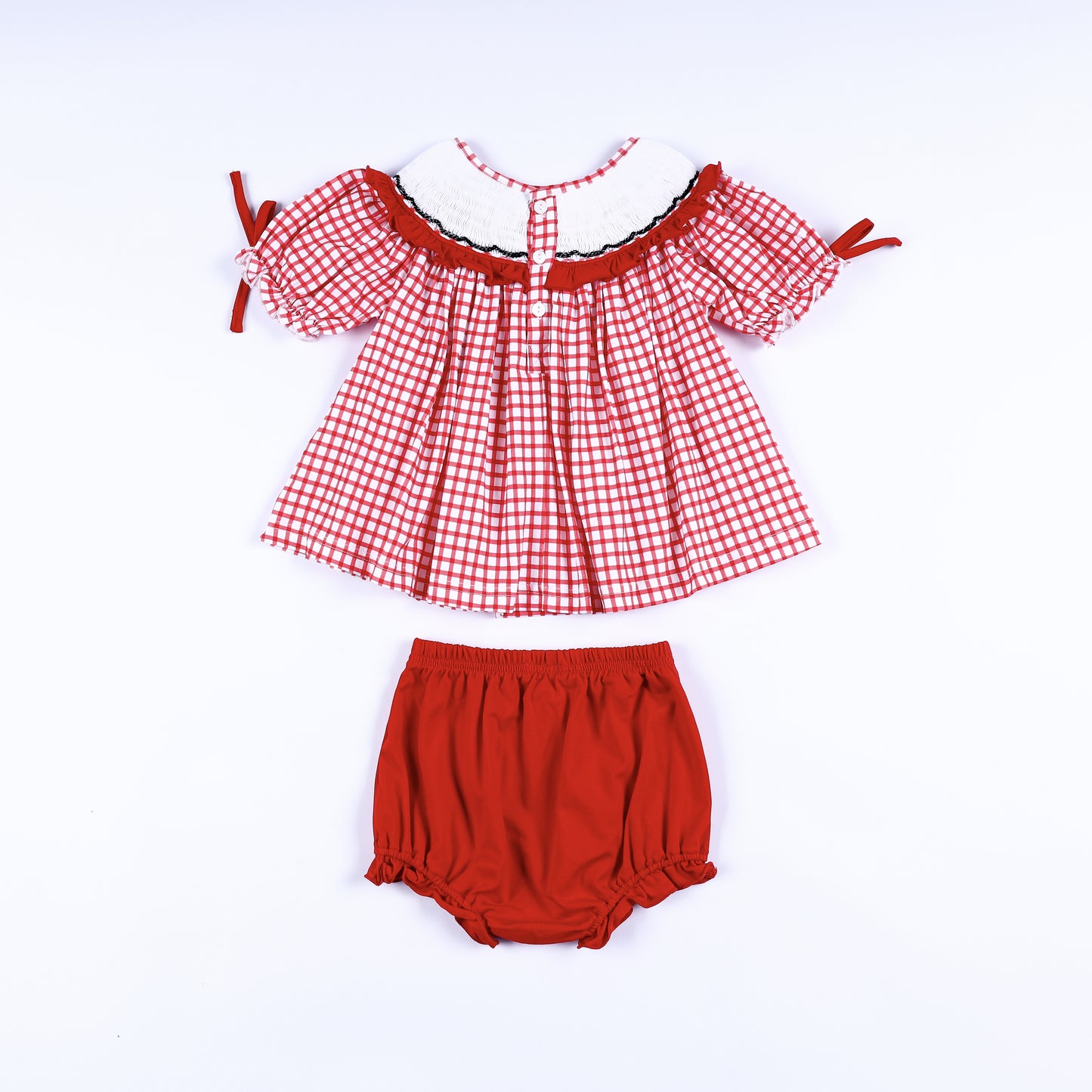 Back view of red gingham hand smocked dress showing button closures with matching solid red diaper cover bloomer.