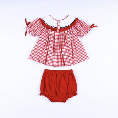Back view of red gingham hand smocked dress showing button closures with matching solid red diaper cover bloomer.
