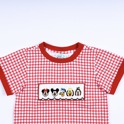 Close up view of the red crew neck collar and hand smocked cartoon character panel on a red gingham boys shirt.