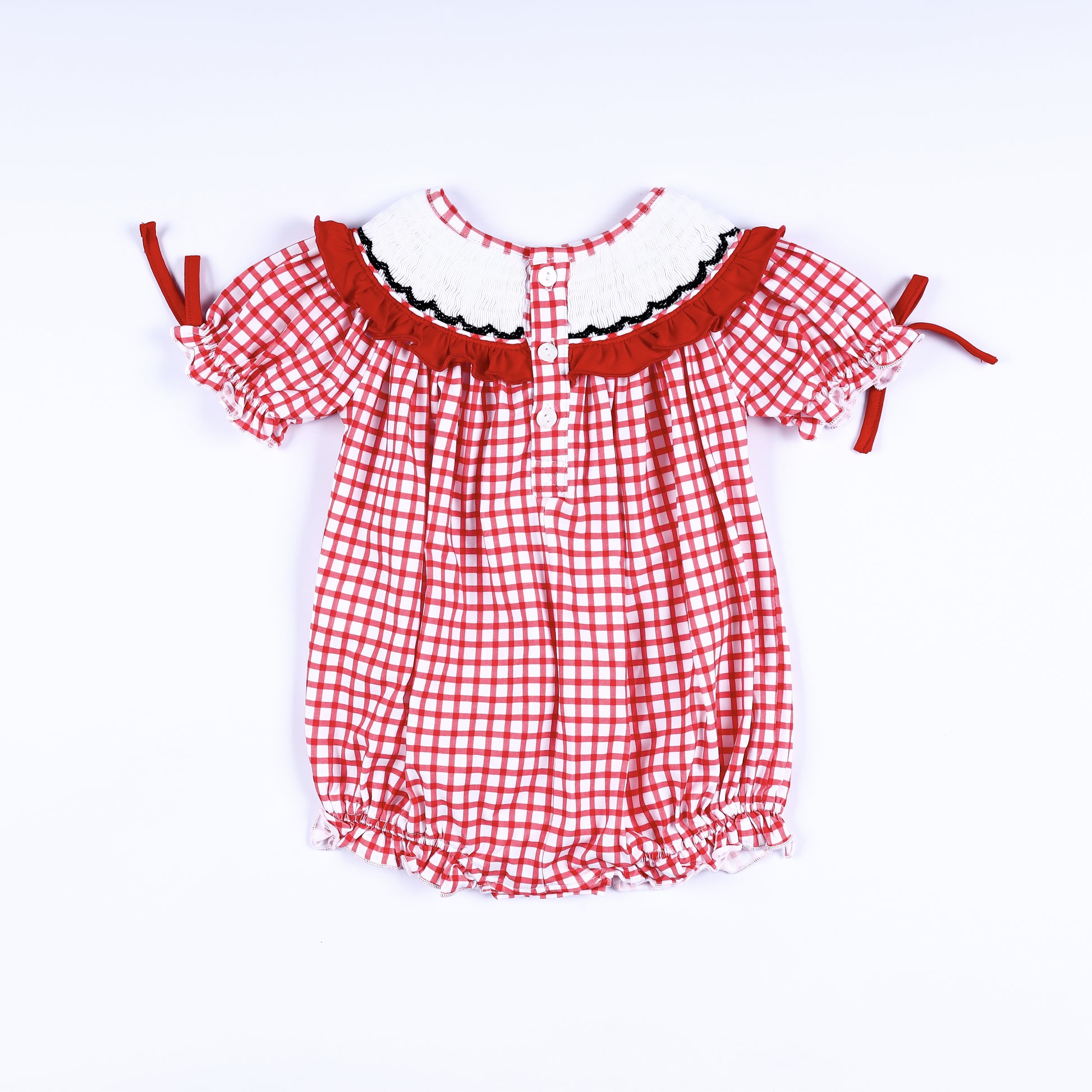 Full back view of red gingham hand-smocked bubble romper showing back button closure placket and ruffled collar.