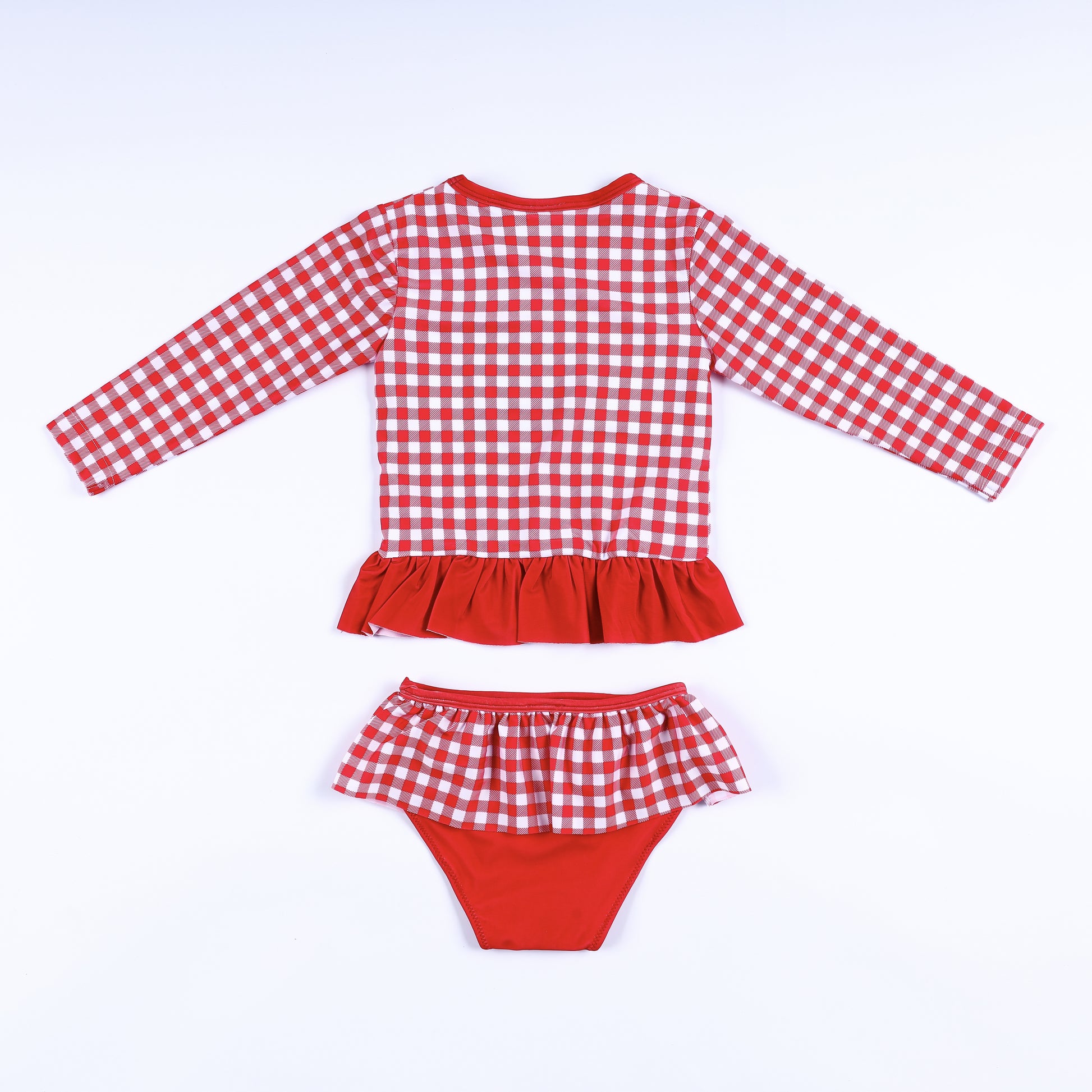 Back view of girls two-piece red gingham long sleeve rash guard swimsuit set with ruffle waist and bottom details.