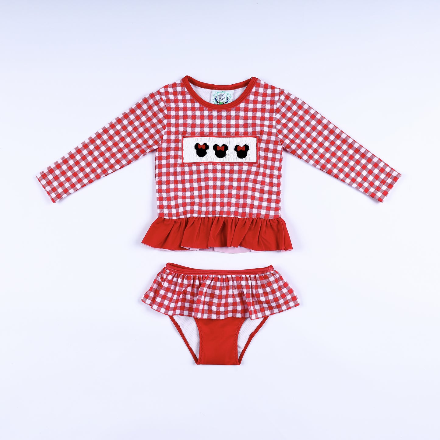 Front view of girls red gingham hand smocked Minnie Mouse two-piece long sleeve rash guard swim set with ruffles.