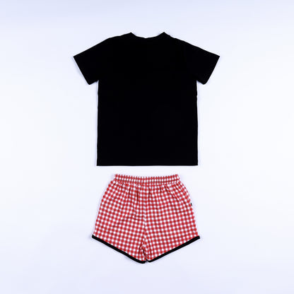 Back view of black short-sleeve shirt and red gingham drawstring shorts for boys smocked clothing set.