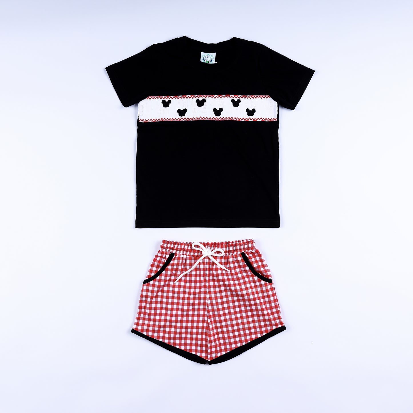 Boys red gingham mouse hand smocked shorts set featuring a black short-sleeve shirt and red checked shorts.