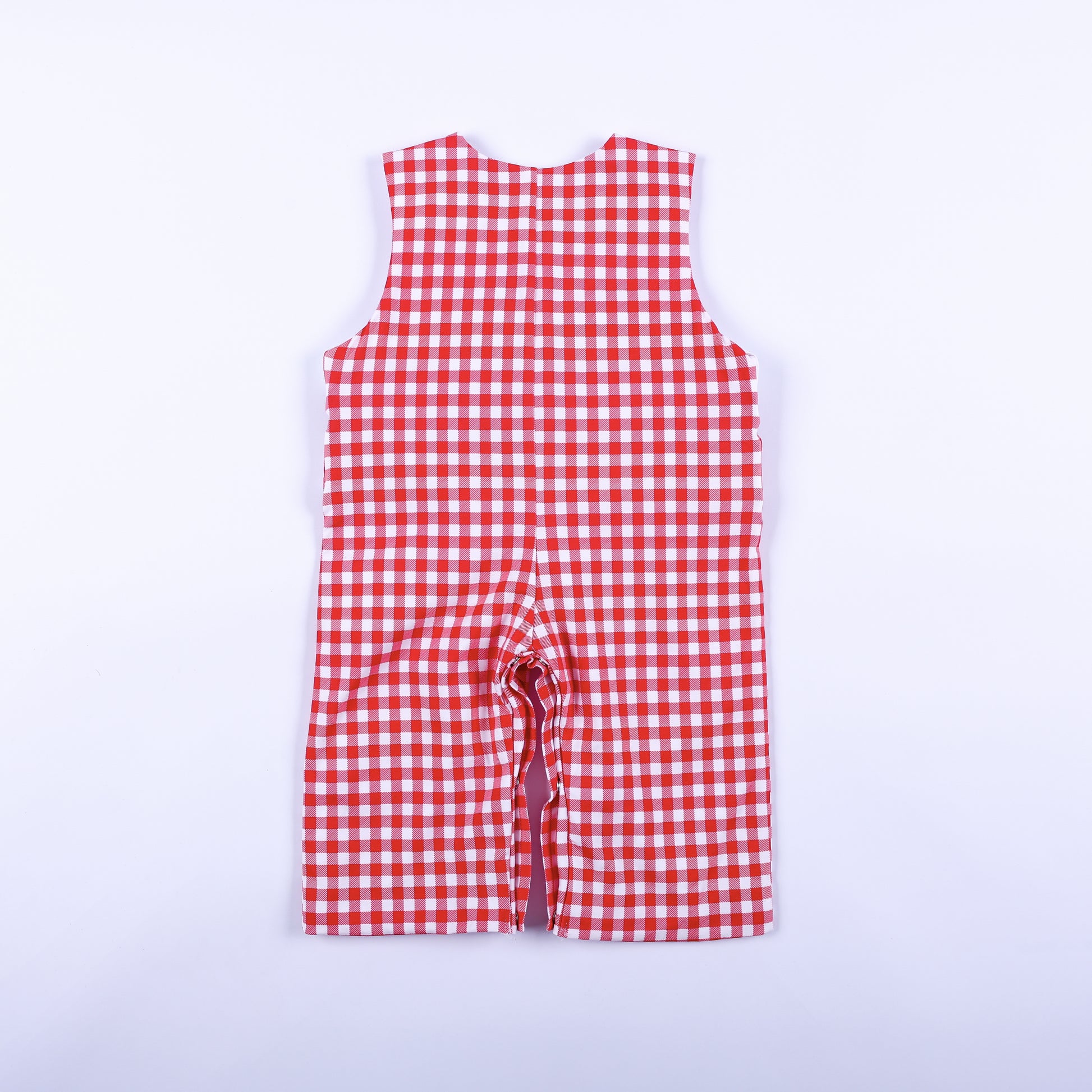 Full back view of boys red gingham hand smocked jon jon featuring classic sleeveless design and check pattern.