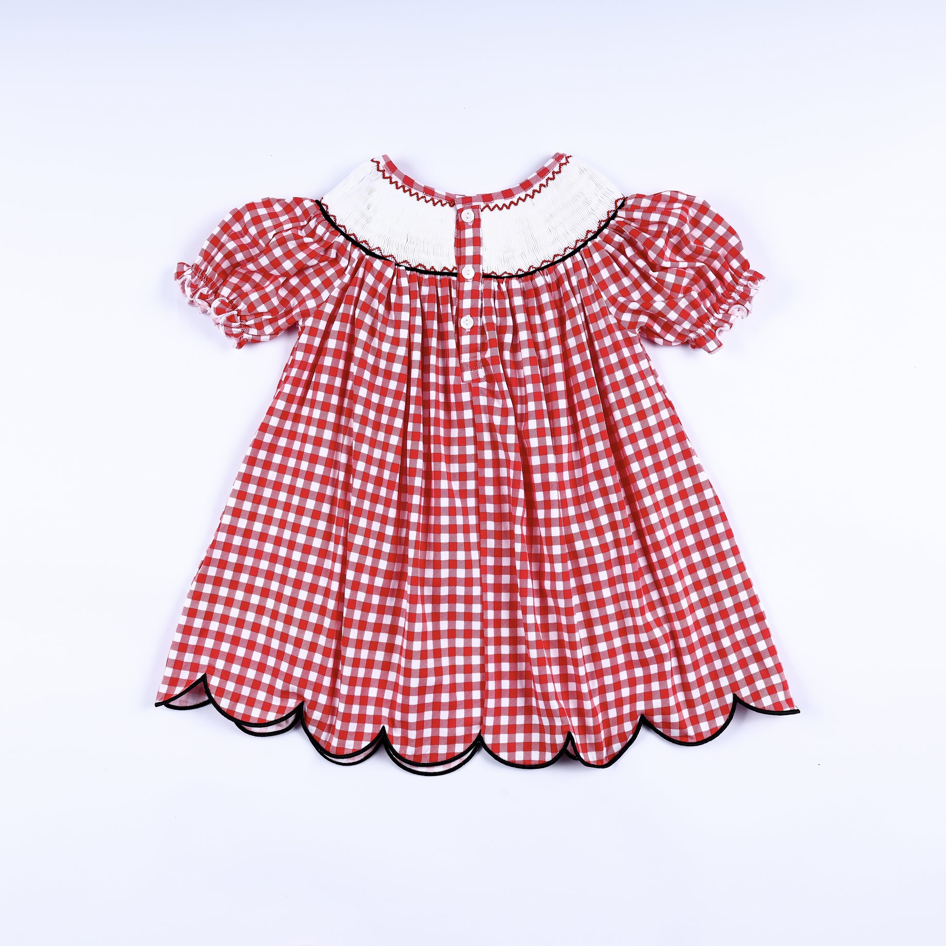 Full back view of the red gingham hand smocked mouse dress showing the button closure and scalloped hem.