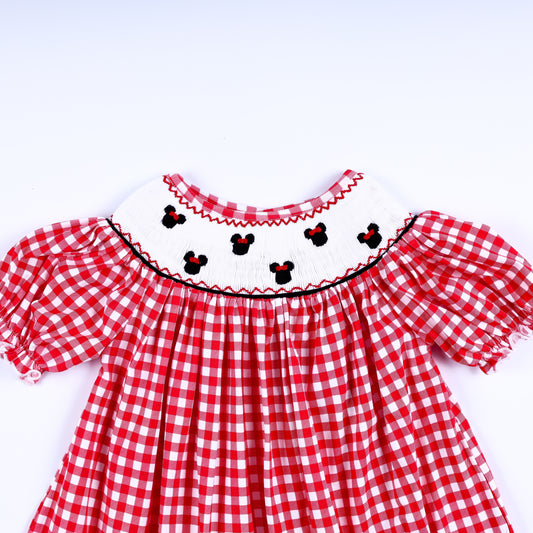 Girls red gingham dress showing the hand-smocked white yoke with embroidered mouse heads and puffed sleeves.