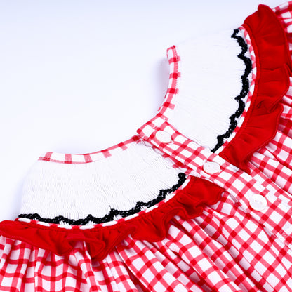 Close-up back detail of white smocked collar and button closure on a red gingham hand-smocked baby bubble outfit.