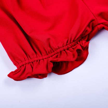 Close-up detail of gathered elastic ruffled cuff on red cotton bloomer shorts for toddler girls set.