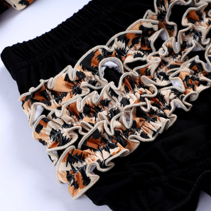 Detailed view of layered leopard animal print ruffles on black hand smocked bloomer set for baby and toddler girls.