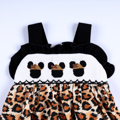 Front bodice smocking with embroidered safari mouse icons on white yoke with black flutter straps and leopard print.