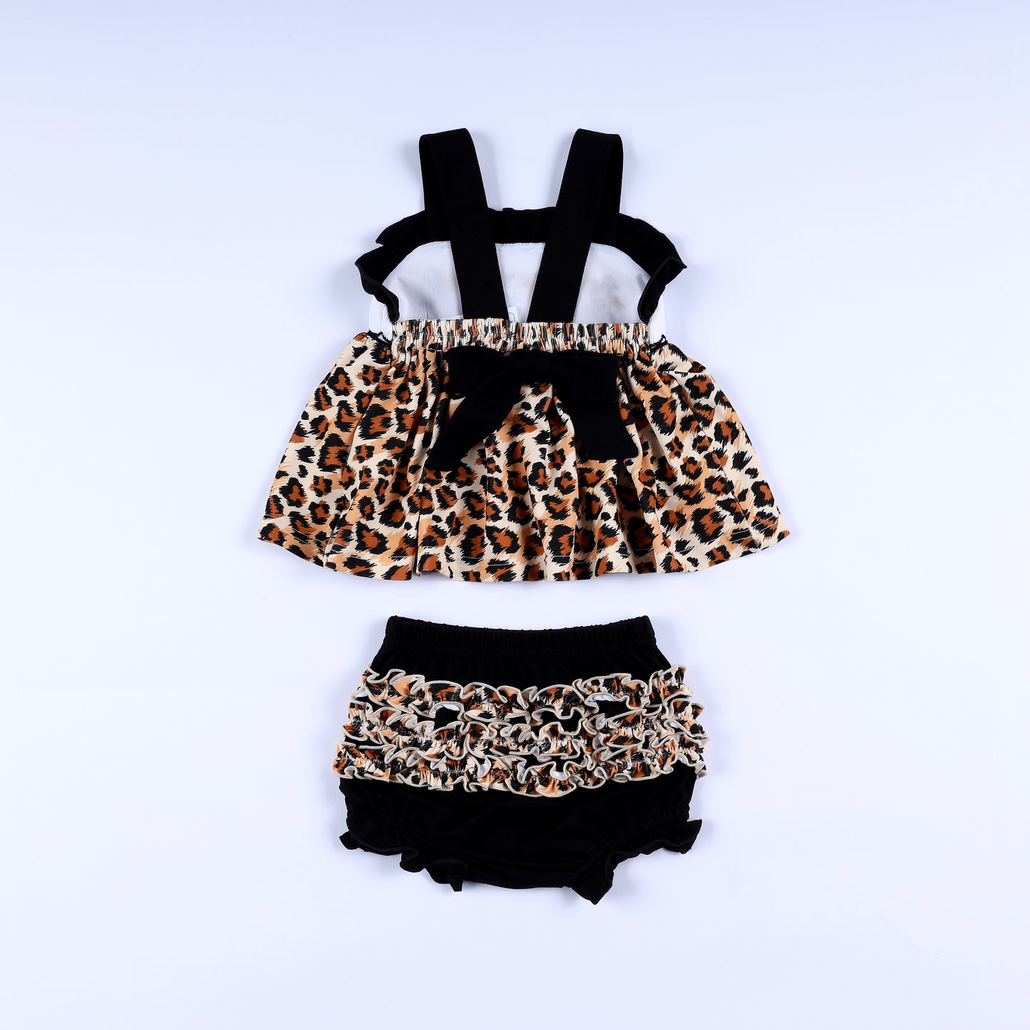 Back view of animal kingdom print safari mouse smocked top with black tie bow and matching ruffled bloomer set.