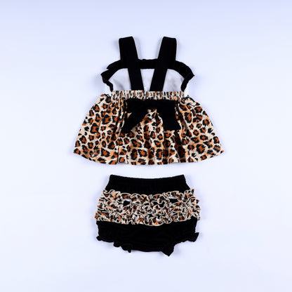 Back view of animal kingdom print safari mouse smocked top with black tie bow and matching ruffled bloomer set.