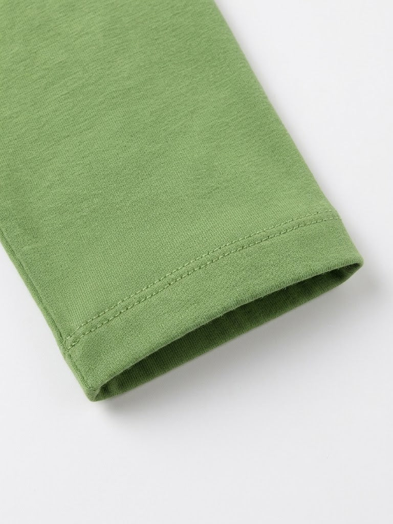 Close-up of a folded green fabric sleeve or cuff with visible stitching on a plain white background.