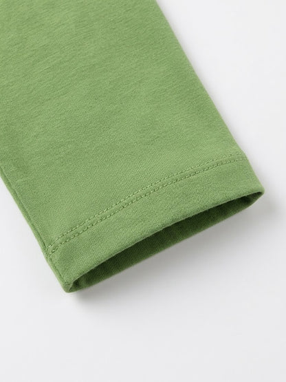 Close-up of a folded green fabric sleeve or cuff with visible stitching on a plain white background.