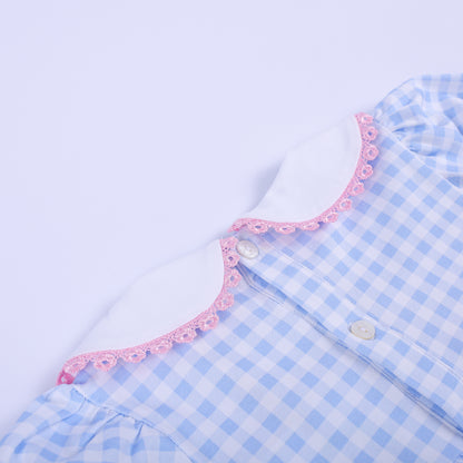 Close-up of the back white Peter Pan collar and button closure on the blue gingham baby shower smocked bubble romper.