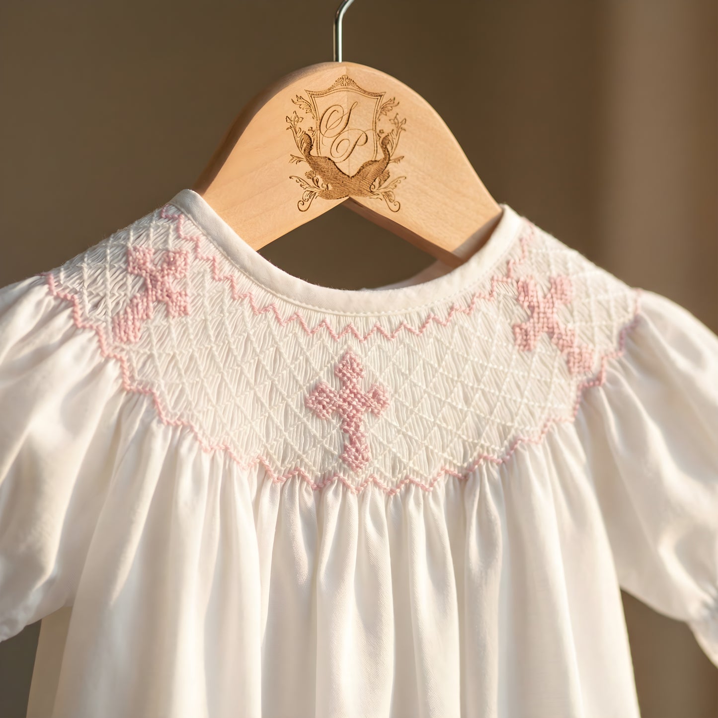 White Sunday Best Girl Bubble featuring a Hand Smocked neckline with Pink Hand Embroidered Crosses.