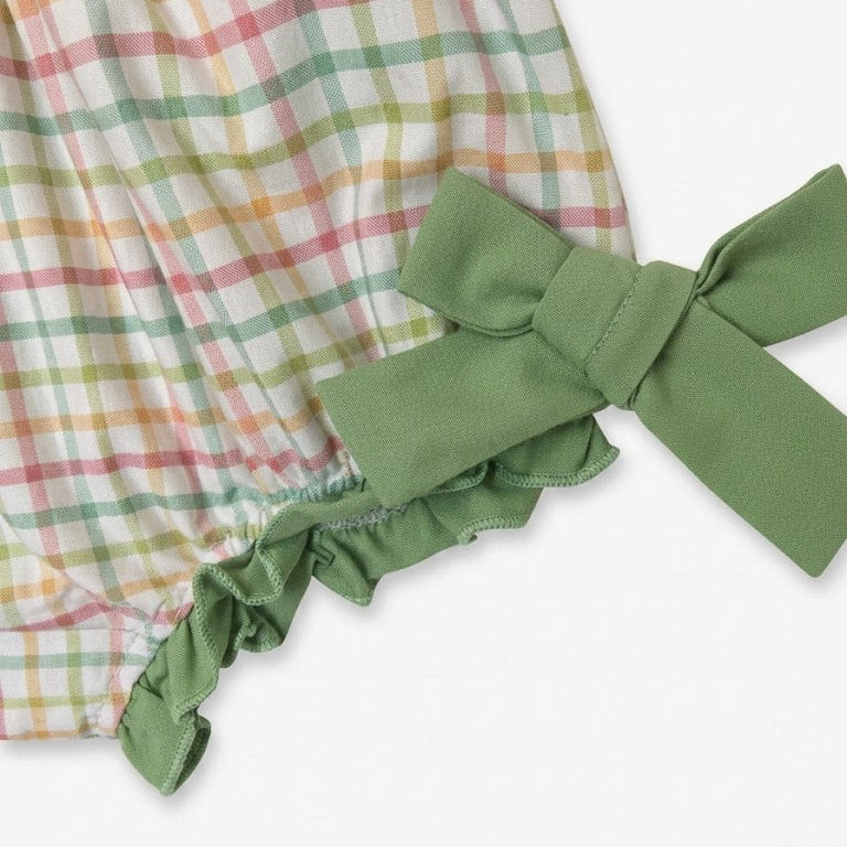 Close-up of sage green side bow tie and ruffled elastic leg opening on baby plaid Thanksgiving romper