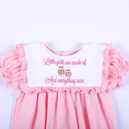 White ruffled collar embroidered with pink sugar and spice everything nice text on a baby girl pink bubble romper.