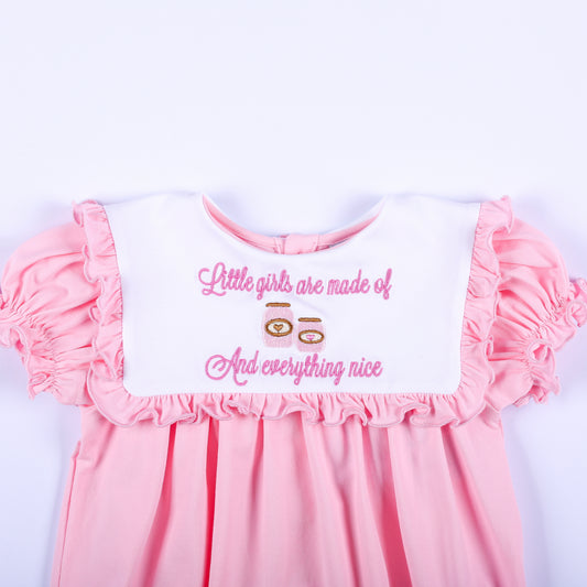 White ruffled collar embroidered with pink sugar and spice everything nice text on a baby girl pink bubble romper.