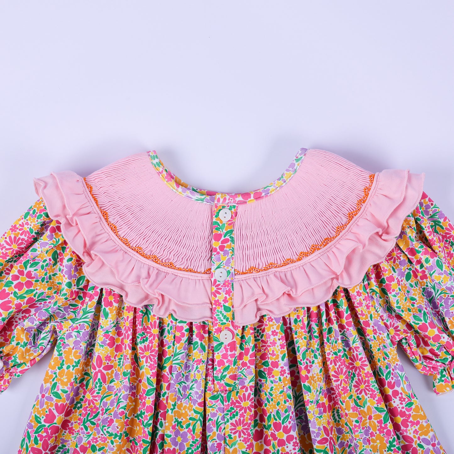 Close-up back view of the pink smocked collar and button closure on the girls boutique Thanksgiving floral tunic.