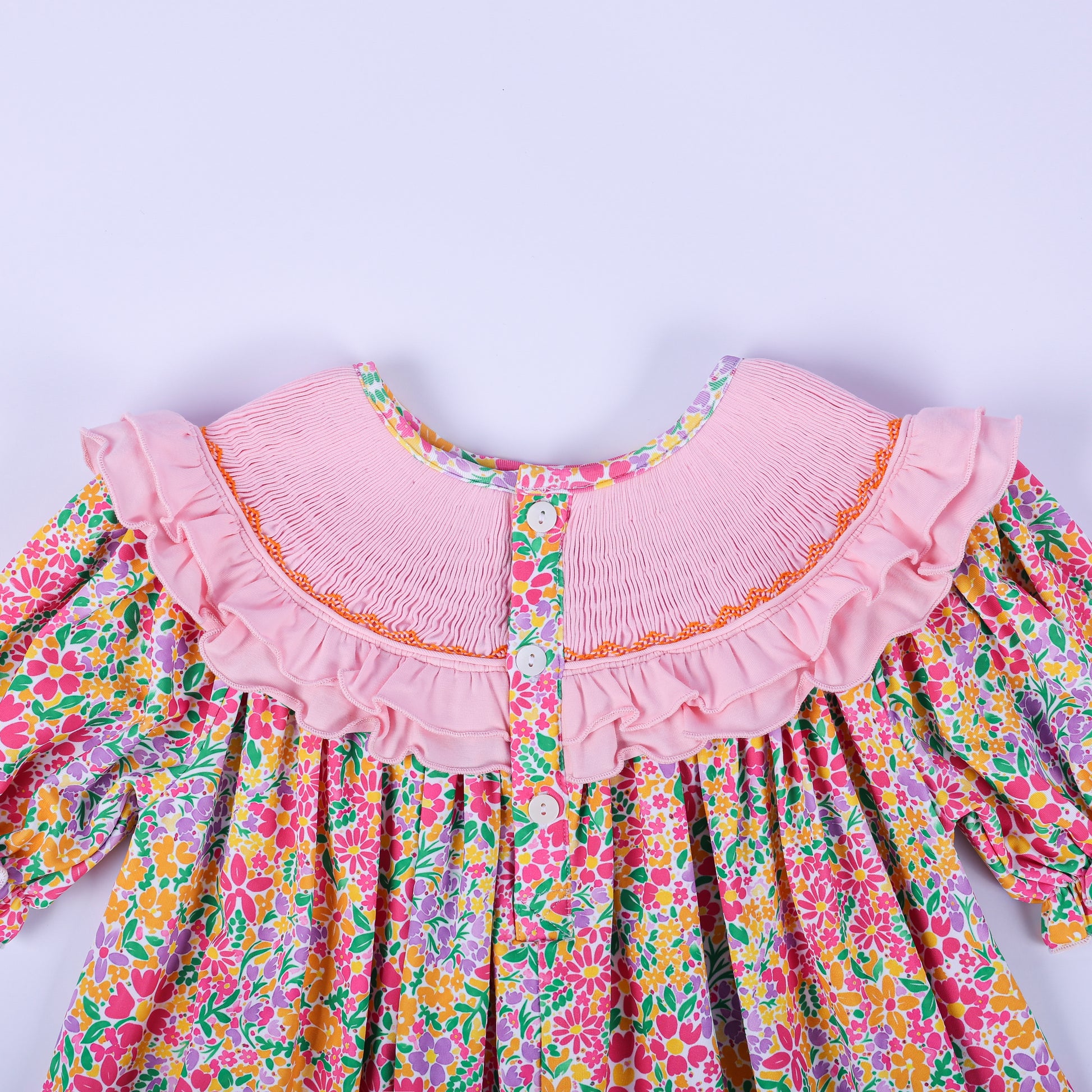 Close-up back view of the pink smocked collar and button closure on the girls boutique Thanksgiving floral tunic.