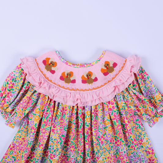 Close-up of the hand-smocked pink collar with embroidered turkeys on the Thanksgiving floral boutique tunic top.