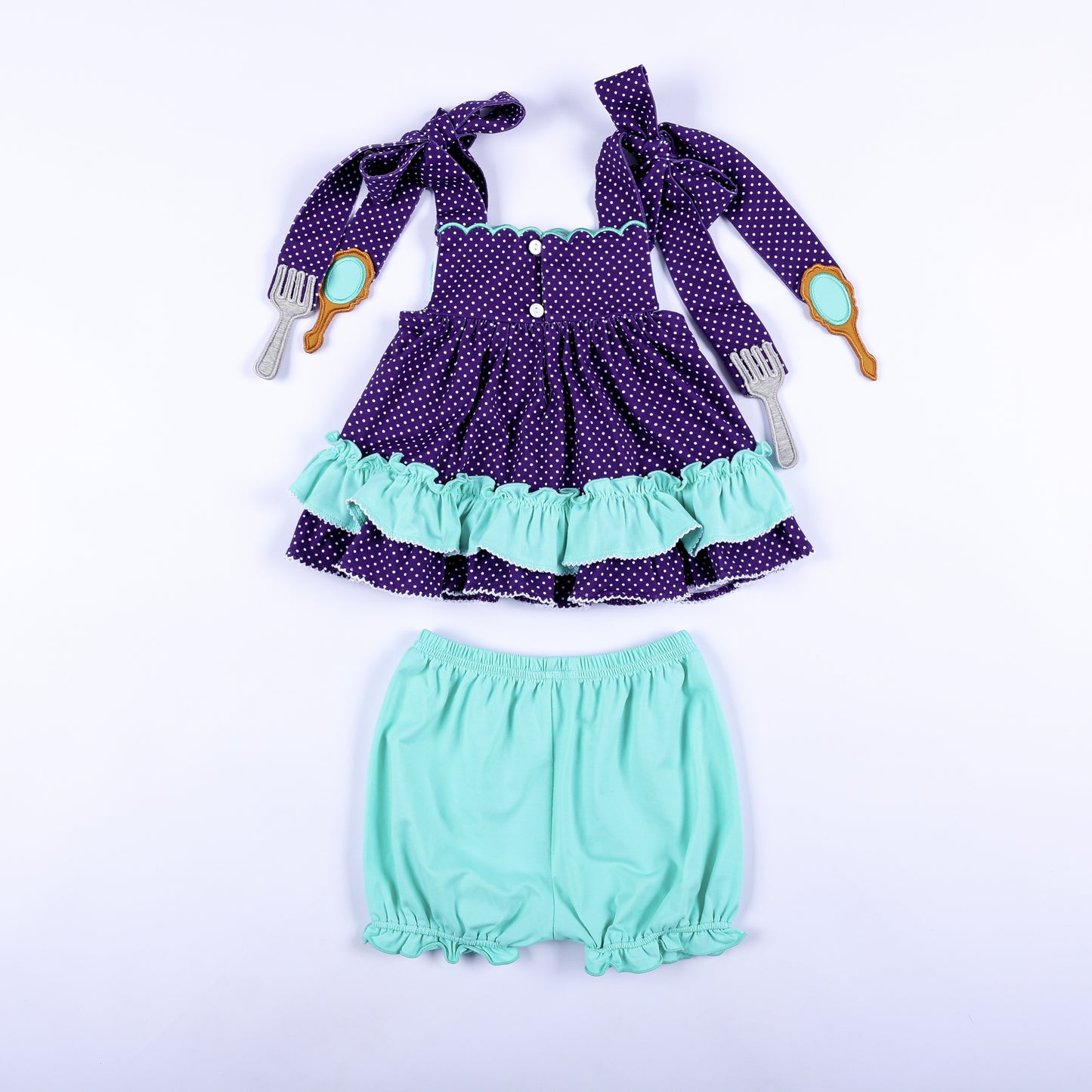 Full back view of Under The Sea hand smocked purple polka dot top with button closures and mint bloomers.