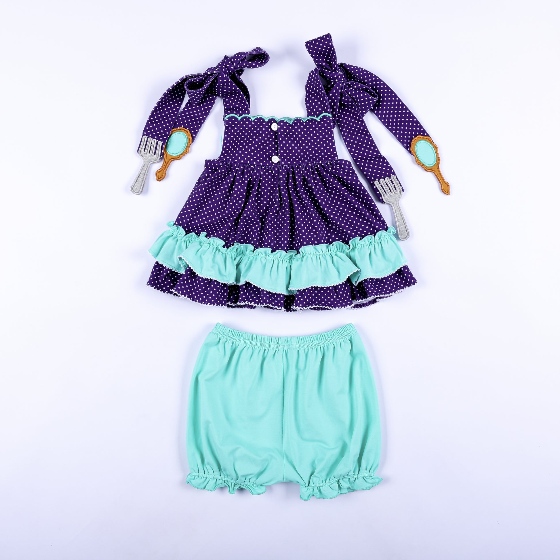 Full back view of Under The Sea hand smocked purple polka dot top with button closures and mint bloomers.