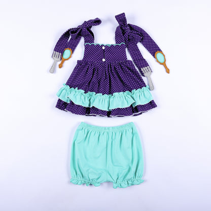 Full back view of Under The Sea hand smocked purple polka dot top with button closures and mint bloomers.